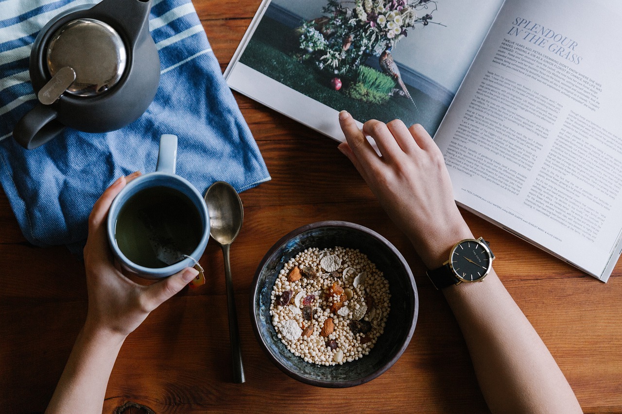 Reading a magazine at breakfast